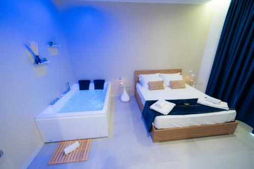 a bathroom with a bed and a bath tub at 5 Stars - Exclusive Luxury Suites with a jacuzzi in Trapani