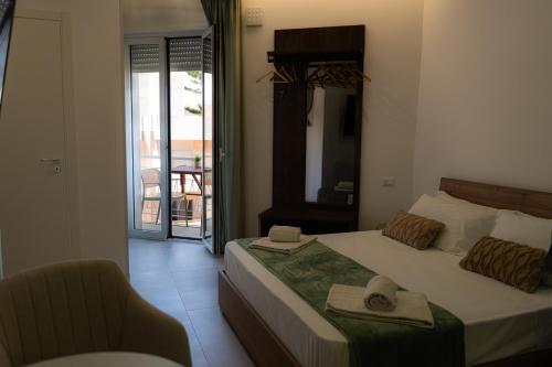 a bedroom with a bed with a hat and a chair at 5 Stars - Exclusive Luxury Suites with a jacuzzi in Trapani