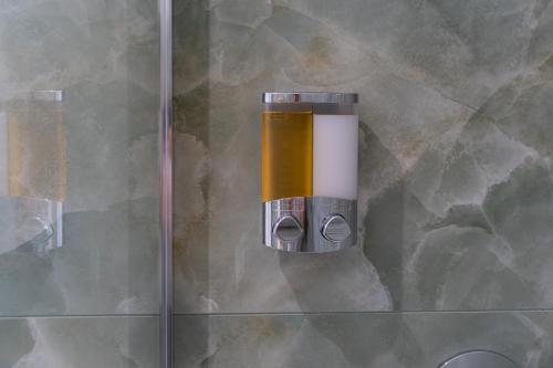 a shower with a glass door with a shower head at 5 Stars - Exclusive Luxury Suites with a jacuzzi in Trapani