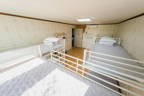 a room with two bunk beds in it at Panda Guesthouse in Gwangju