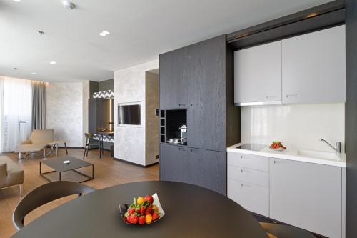 a kitchen with a table with a bowl of fruit on it at Maritim Hotel Plaza Tirana in Tirana