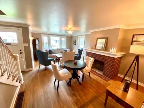 a living room with a table and chairs and a fireplace at Family Home in mainheim PA close to atractions in Manheim