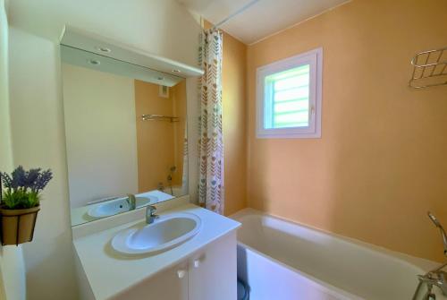 a bathroom with a sink and a bath tub at Les Naïades I55 - 2 bedroom for 4 people in Avène
