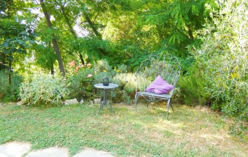 a chair with a purple pillow sitting in a garden at Il Laghello Wood House in Framura