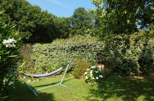 a hammock sitting in the grass in a garden at Il Laghello Wood House in Framura