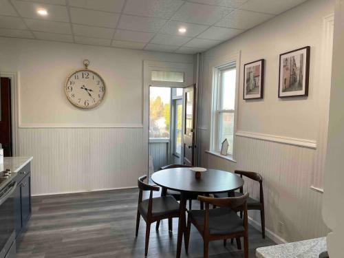 un comedor con una mesa y un reloj en la pared en Cozy Lancaster Apartment Near Attractions, en Lancaster