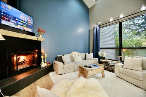 a living room with two couches and a fireplace at Windham Ridge Chalet in Windham