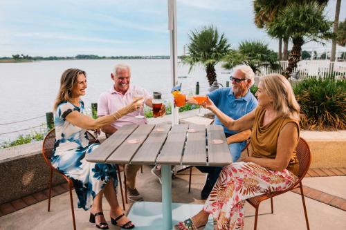 a group of people sitting around a table drinking drinks at The Waterfront Inn in The Villages