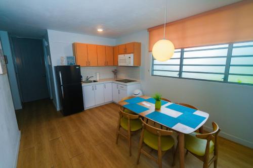 a kitchen with a table and chairs and a refrigerator at Rincon of the Seas Grand Caribbean Hotel in Rincon