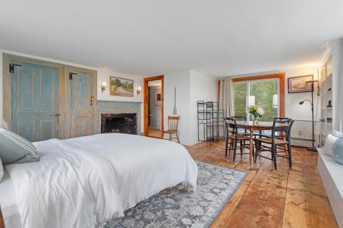 a bedroom with a bed and a table and chairs at Highland Catttle Farm - Cozy Suite for Two - C in Loudon