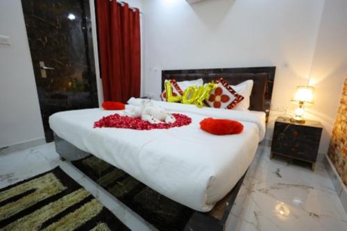 a bedroom with a bed with red flowers on it at Hotel Rajani Best Hotel In Bareilly AC OR NON AC Room in Bareilly