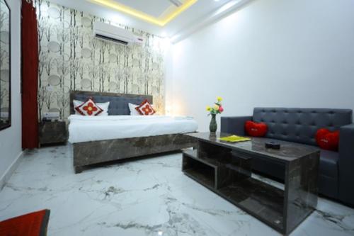 a bedroom with a king sized bed and a couch at Hotel Rajani Best Hotel In Bareilly AC OR NON AC Room in Bareilly