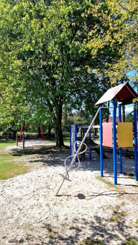 a playground in a park with a swing at EcoCube 142 - Balkon, 3Zimmer, Schlafsofa, Waschmaschine, Backofen, 6Pers in Meppen