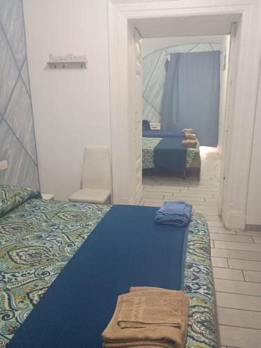 a bedroom with two beds and a mirror at B&B La casa di Cò in Naples