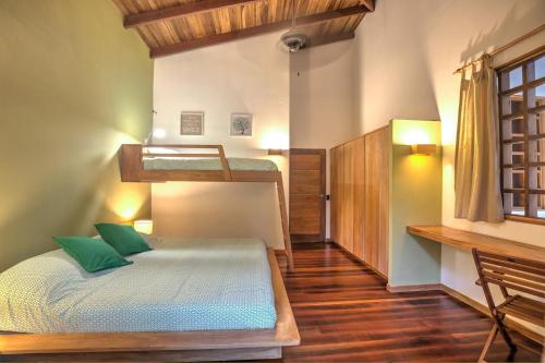 a bedroom with a bunk bed and a desk at Shawandha Villas in Punta Uva