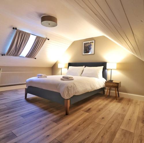 a bedroom with a bed with two lamps and a window at Newly Refurbished Self-Catering Lodge Sleeping 3 in Wexford