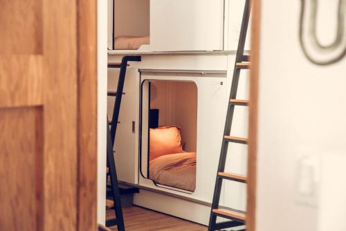 a room with two bunk beds and a mirror at STAY OPEN Venice Beach in Los Angeles
