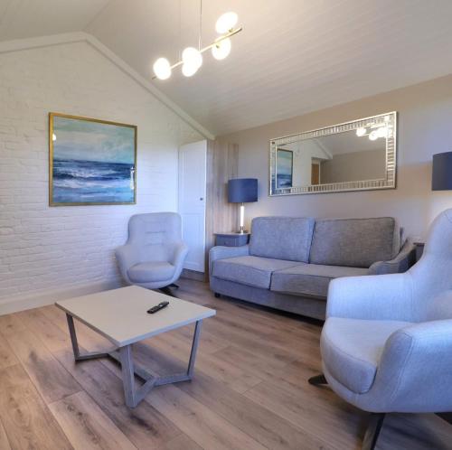a living room with a couch and a table at Newly Refurbished Self-Catering Lodge Sleeping 3 in Wexford