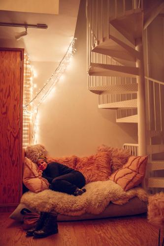 a person laying on a bed in a room with a dog at STAY OPEN Venice Beach in Los Angeles