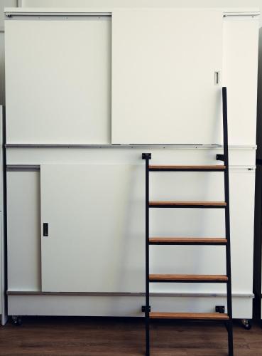 a shelf with two white cabinets and a ladder at STAY OPEN Venice Beach in Los Angeles
