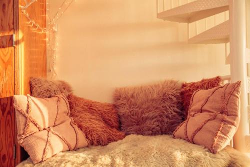 a pile of pillows sitting on a couch at STAY OPEN Venice Beach in Los Angeles