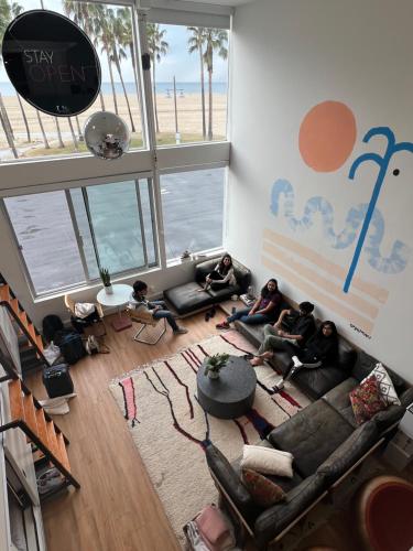 a group of people sitting in a living room at STAY OPEN Venice Beach in Los Angeles