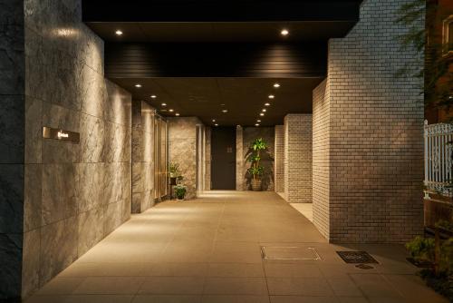 a hallway of a building with a lighted walkway at brand-new hotel, a 3-minute walk from Asakusa Kuramae Statio in Tokyo