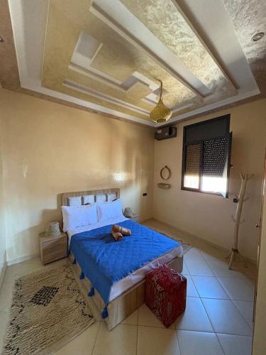 a bedroom with a teddy bear laying on a bed at Room blue in Marrakesh, 2 min Airport in Marrakech