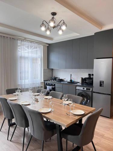 a dining room table with chairs and a kitchen at Rent House Dilijan in Dilijan
