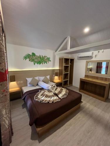 a bedroom with a large bed in a room at Coral Beach Seaside in Gili Trawangan