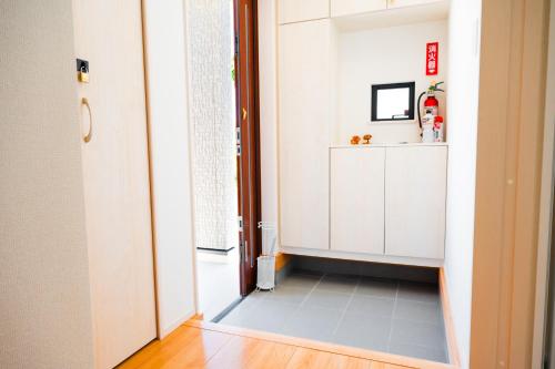 a hallway with a door open to a room at IBUNOYA Yaese in Yaese