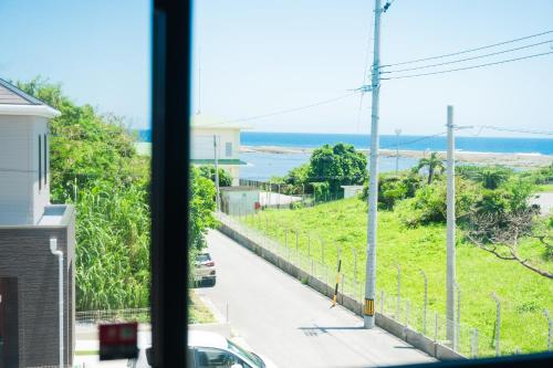 a view of the ocean from a window at IBUNOYA Yaese in Yaese