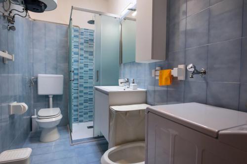 a bathroom with a toilet and a sink and a shower at Vista Mare Paradiso by Salento Prime in Torre Vado