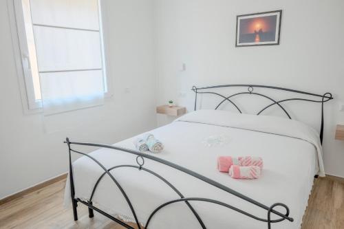 a bedroom with a bed with two pillows on it at SK Barigau in Lanusei