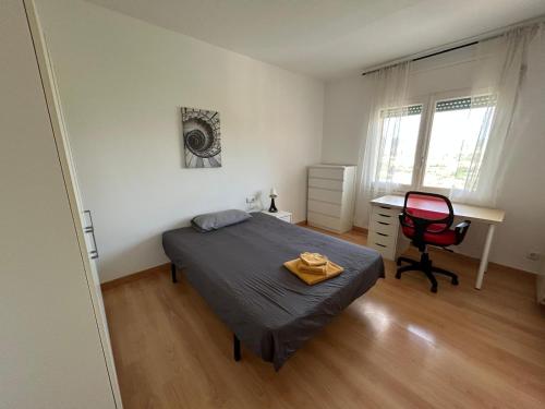 a bedroom with a bed and a desk and a chair at Apartamento de 3 habitaciones en GIRONELLA - ALBERGA in Gironella