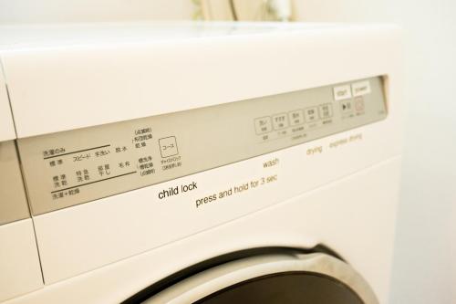 a washing machine with the words child ok on it at IBUNOYA Yaese in Yaese