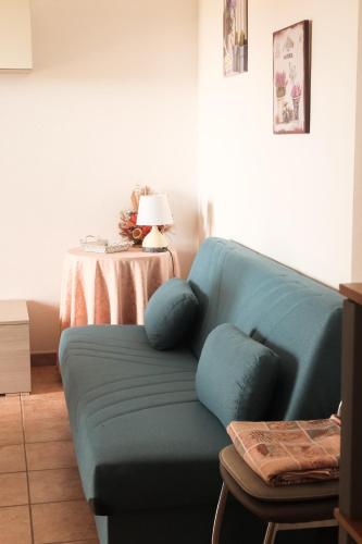 a blue couch in a living room with a table at Casa Cristallina in Posada