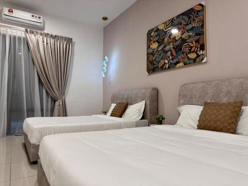 a hotel room with two beds and a window at Warm & Cozy Home in Kampong Duson Gilap