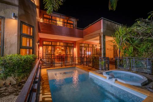 a house with a swimming pool in front of it at Villa centre Grand Baie in Grand Baie