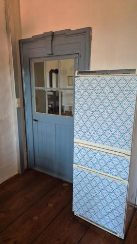 a blue door in a room next to a door with a window at Cool Flat at Renaissance Castle - 2BR in Kalsdorf bei Ilz