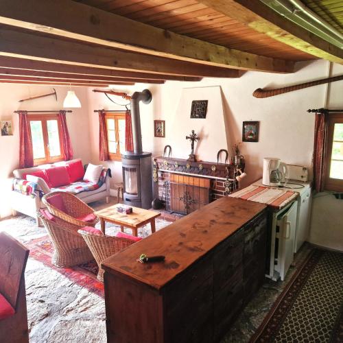 a living room with a stove and a fireplace at Tourbillon Gerber - Chalet authentique La Sage in La Sage