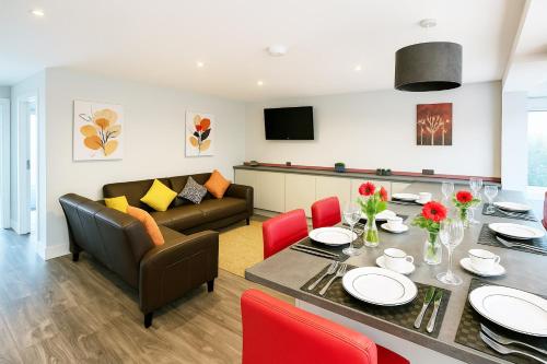 a living room with a table and a couch at Maidstone House Kent By Smart Corporate Stays in Maidstone