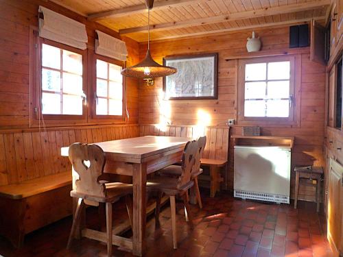 a dining room with a wooden table and chairs at Chalet Le Recoulet 4 personnes - Evolene in Evolène