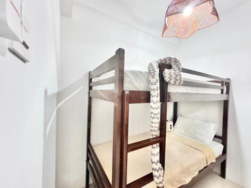 a bunk bed in a room with a lamp at Cozy 2BR Apartment in City Square East Surabaya by Le Ciel Hospitality in Surabaya