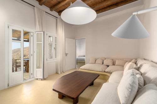 a living room with a couch and a table at Petradi Studios & Villa in Aegiali