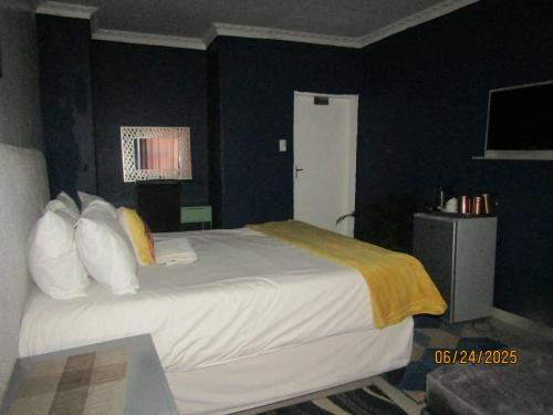 a bedroom with a large bed in a room at The PHOMOLONG GUEST HOUSE in Roodepoort