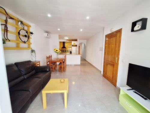a living room with a couch and a table at Apartamentos Catalina C in Turre