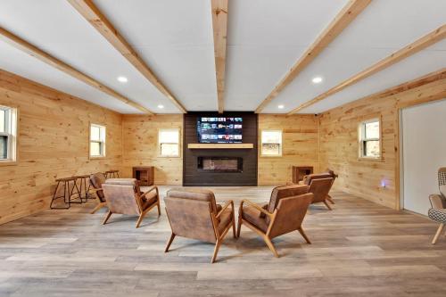 a room with chairs and a flat screen tv at Water and Electric 30 Amp Pull through up to 24 Site ONLY in Gaines