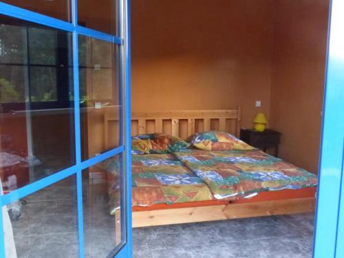 a bedroom with a bed and a window at Casa Cecilia Seaside Serenity and Coastal Charm in Coimbrão