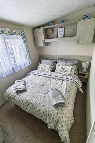 a bedroom with a bed with two towels on it at 13 The Avenue in Tattershall